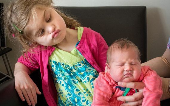 Alicja Nowicki, 10, who has Charge Syndrome, with baby sister, Ida.