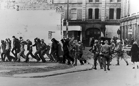 Civilians ushered off the streets, with their hands raised, by British soldiers on Bloody Sunday.