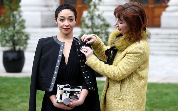 Minister for Culture Josepha Madigan pinning a brooch to Cultural Ambassador Ruth Negga's lapel.