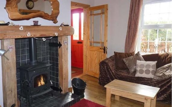 A wood-burning fire in the Summerhill Cottage sitting room.