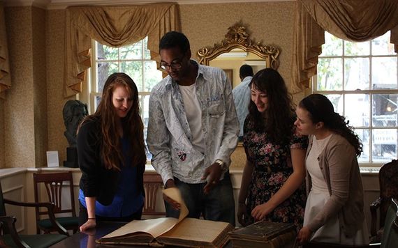 Students engage over an old manuscript in one of the main rooms at Glucksman Ireland House.