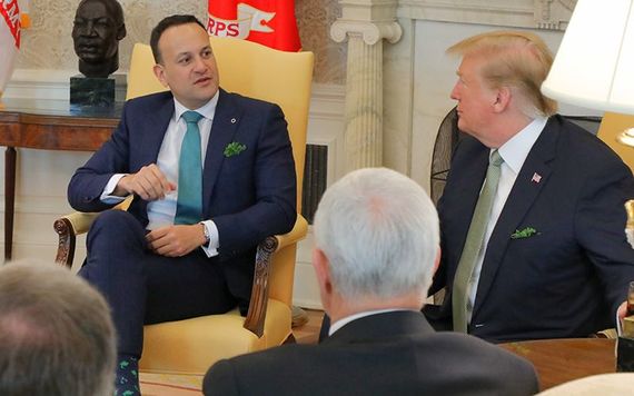 Trump receives the traditional shamrock from Varadkar.