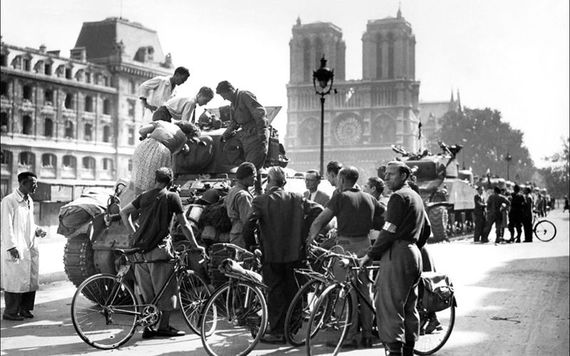 A photo during the liberation of Paris, in World War II, with Notre Dame in the background.