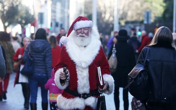 Santa Claus himself, walking up College Green, in Dublin, at Christmas.