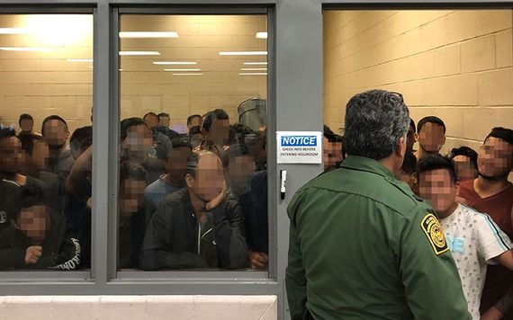 Men crammed into cells with hardly enough room to stand.