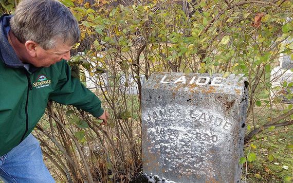 Mike using chalk to highlight his second great grandfather's gravestone that Kate discovered hidden for decades behing overgrown shrubs. When visiting cemeteries, "leave no stone unturned"!