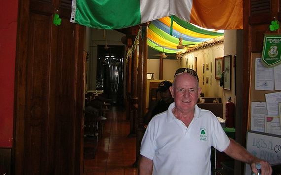 Tom Griffin stands proudly under an Irish flag at his pub in Nicaragua. Photo: Ciaran Tierney