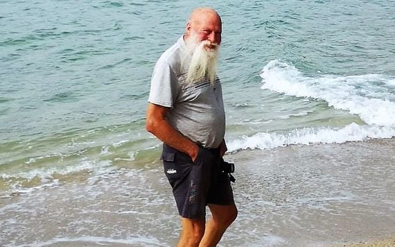 Dan Hummel on the beach on his land.