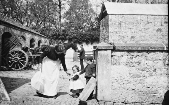 A mother and children in the yard. Image: Dillon Family/National Library of Ireland