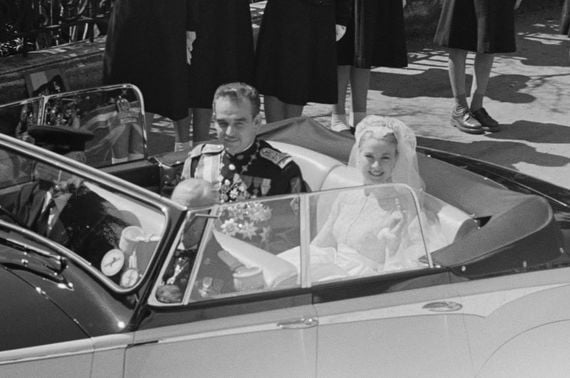 April 19, 1956: Grace Kelly and Rainier III, Prince of Monaco, driven through the streets of Monte Carlo in a convertible car following their wedding. (Photo by Joseph McKeown/Picture Post/Hulton Archive/Getty Images) April 19, 1956: Grace Kelly and Rainier III, Prince of Monaco, driven through the streets of Monte Carlo in a convertible car following their wedding. (Photo by Joseph McKeown/Picture Post/Hulton Archive/Getty Images)