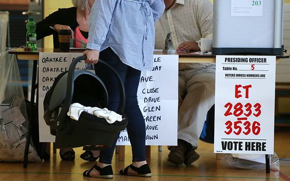 A woman carries a baby to the polls during the May 25 abortion referendum.
