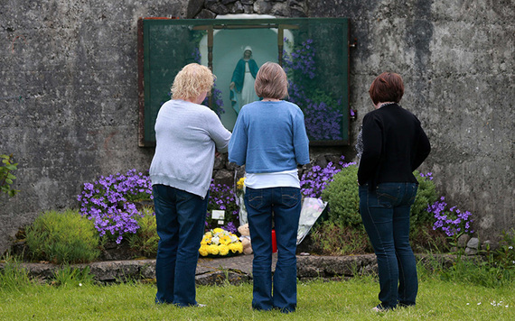 Women pay their respects at the grotto by the site of where 796 children from the Bon Secour Mother and Child home are believed to be buried.