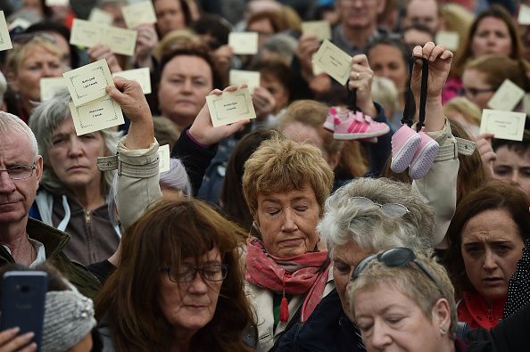 The names of the victims are read out as a vigil takes place at the site of the mass grave which contained the remains of 796 named babies from the Bon Secours Mother and Baby home on August 26, 2018, in Tuam, Ireland. (Photo by Charles McQuillan/Getty Images)