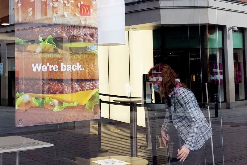July 22, 2020: Pictured is a staff member wearing a face mask and cleaning inside McDonald's on Grafton Street in Dublin as they today announced they have reopened dine-in areas in 32 of its restaurants nationwide. 